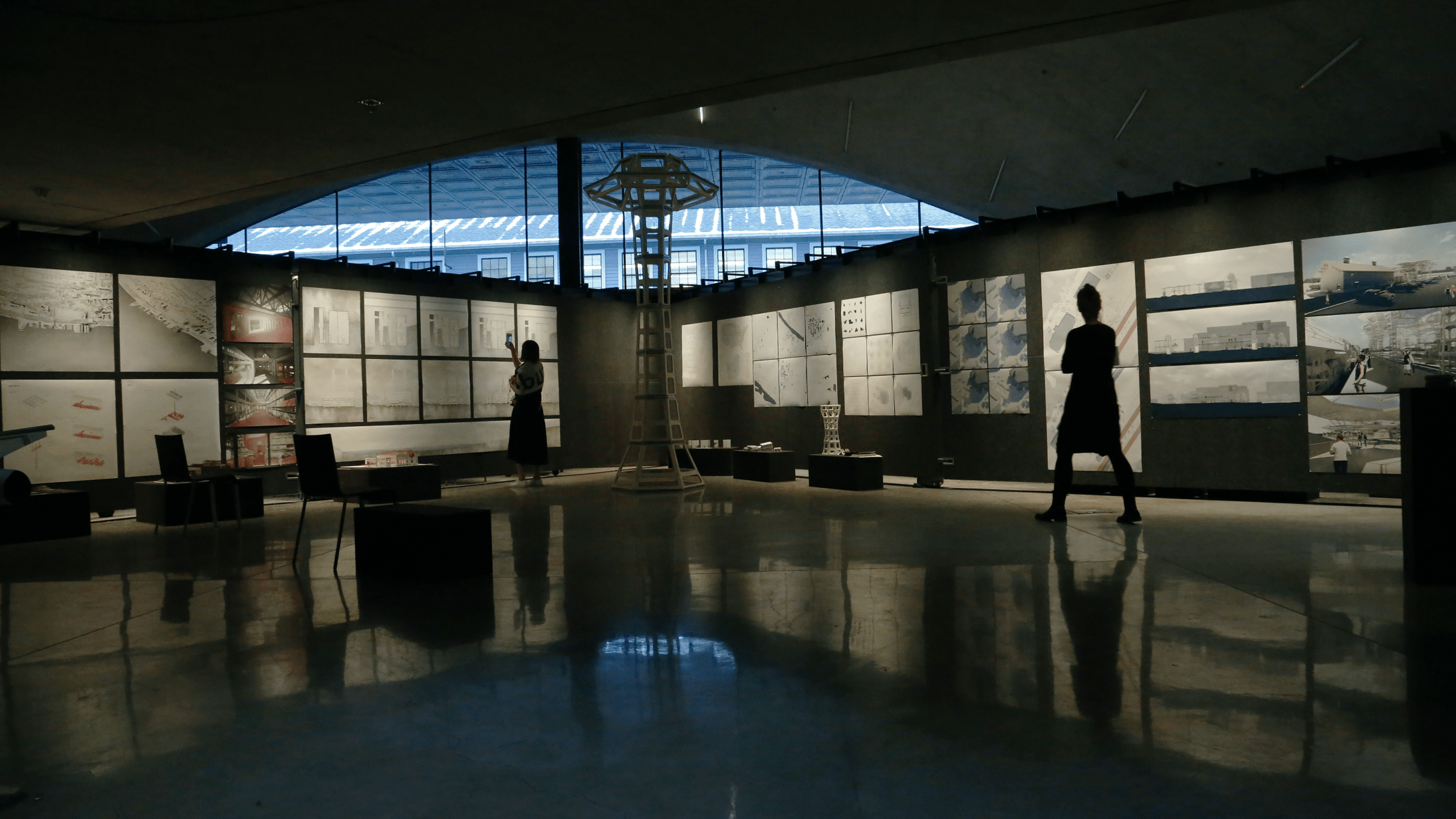 A person standing in a dimly lit room with a ceiling cutout.