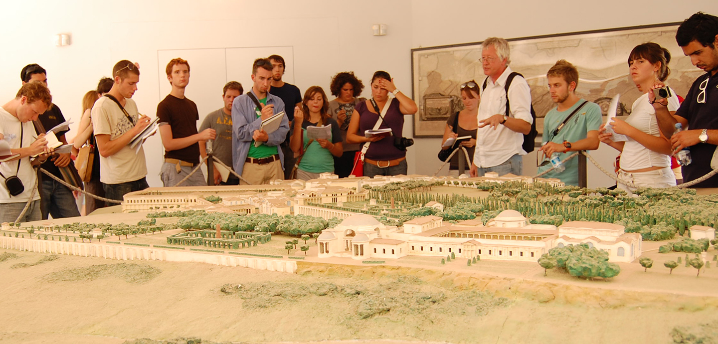 Students and instructors view a 3D map of an ancient Italian city.