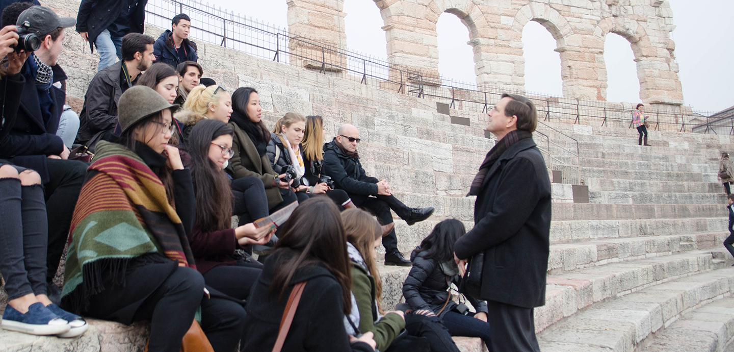 Jeffrey Blanchard describes to students an ancient colosseum during a trip to northern Italy.