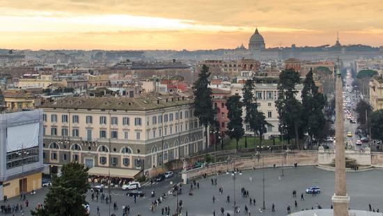 panoramic view of Rome with orange and yellow-toned sky