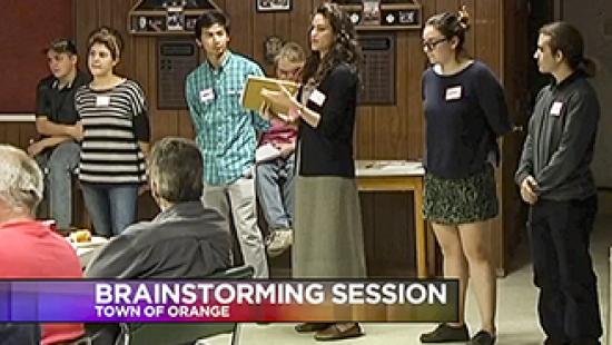 students in a community meeting, text reads Brainstorming Session