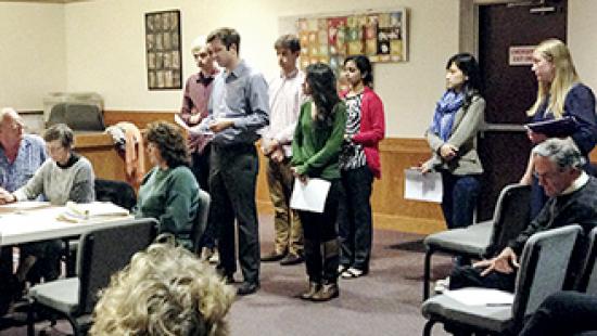 A group of people standing in a room.