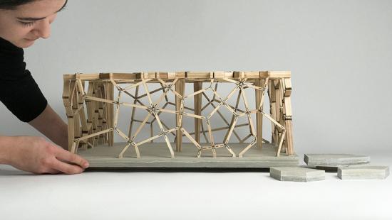 Architectural model constructed out of wood and elevated on a platform. 