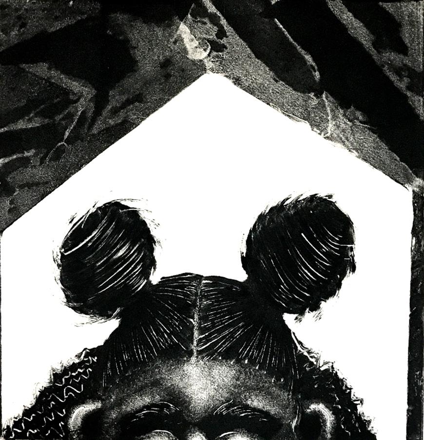 Black and white print of someone's hair in pigtail buns.