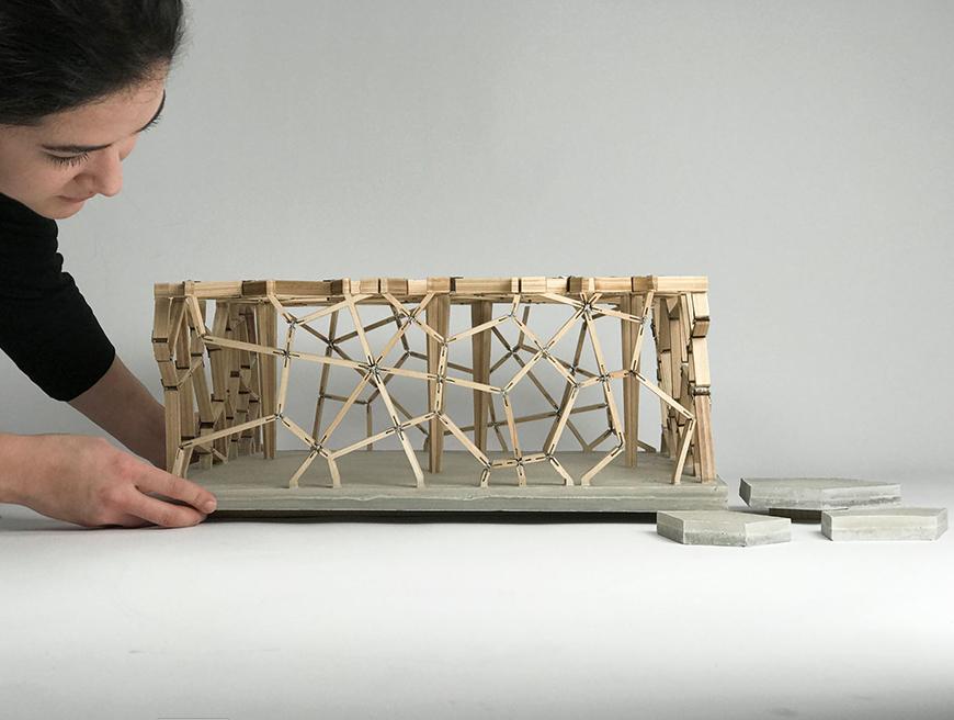 Architectural model constructed out of wood and elevated on a platform. 