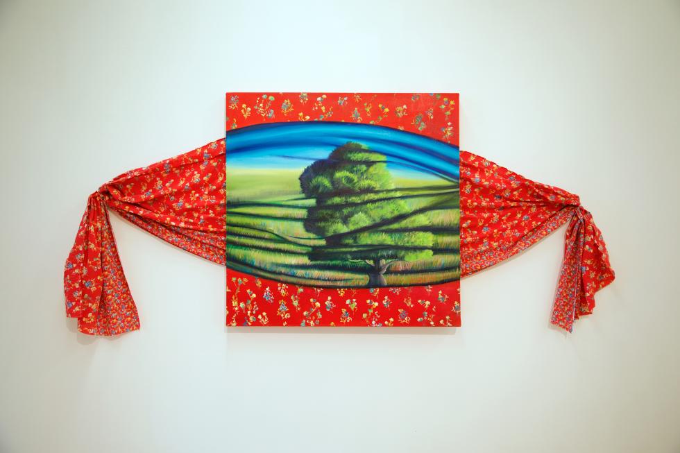 Red fabric with small flowers printed across it tied at the ends with a painting of a tree in the middle on canvas made to look like fabric.