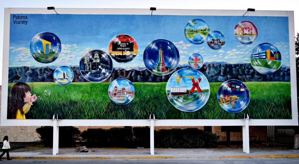 Billboard depicting a small child in the corner blowing bubbles, within each bubble is a landmark within Mexico.